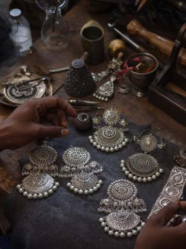 Local artisans curating intricate design silver pieces using traditional tools