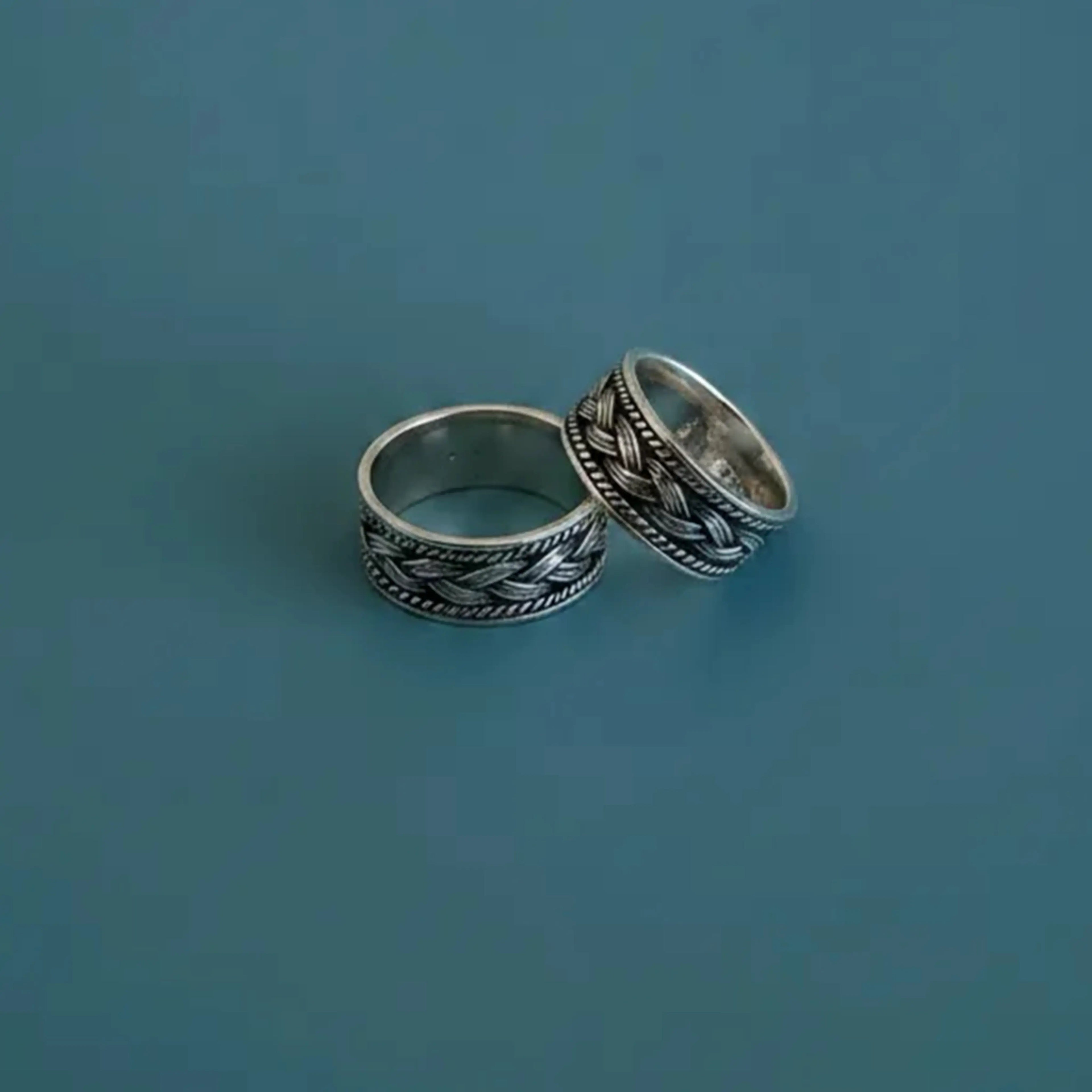 Oxidized Celtic Braid Toe Rings on solid background