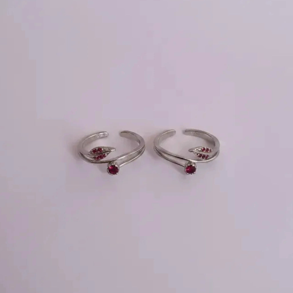 ruby rosebud Toe Rings on solid background