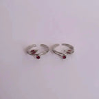 ruby rosebud Toe Rings on solid background