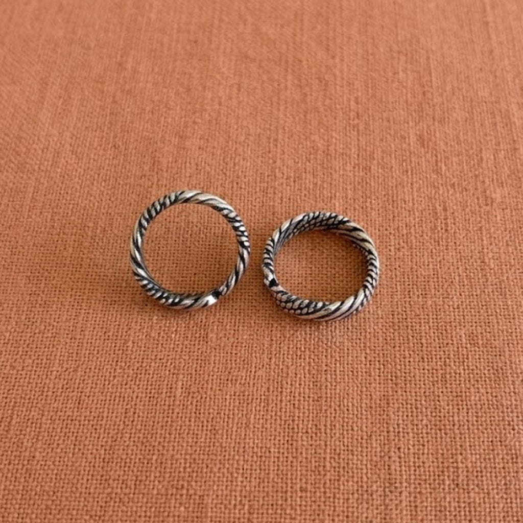 Multi-Textured Oxidized Twist Toe Rings on solid background