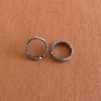 Multi-Textured Oxidized Twist Toe Rings on solid background