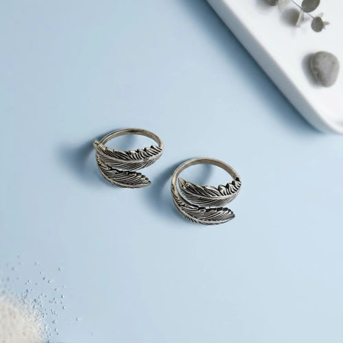 Double Feather Oxidized Bypass Toe Rings on solid background