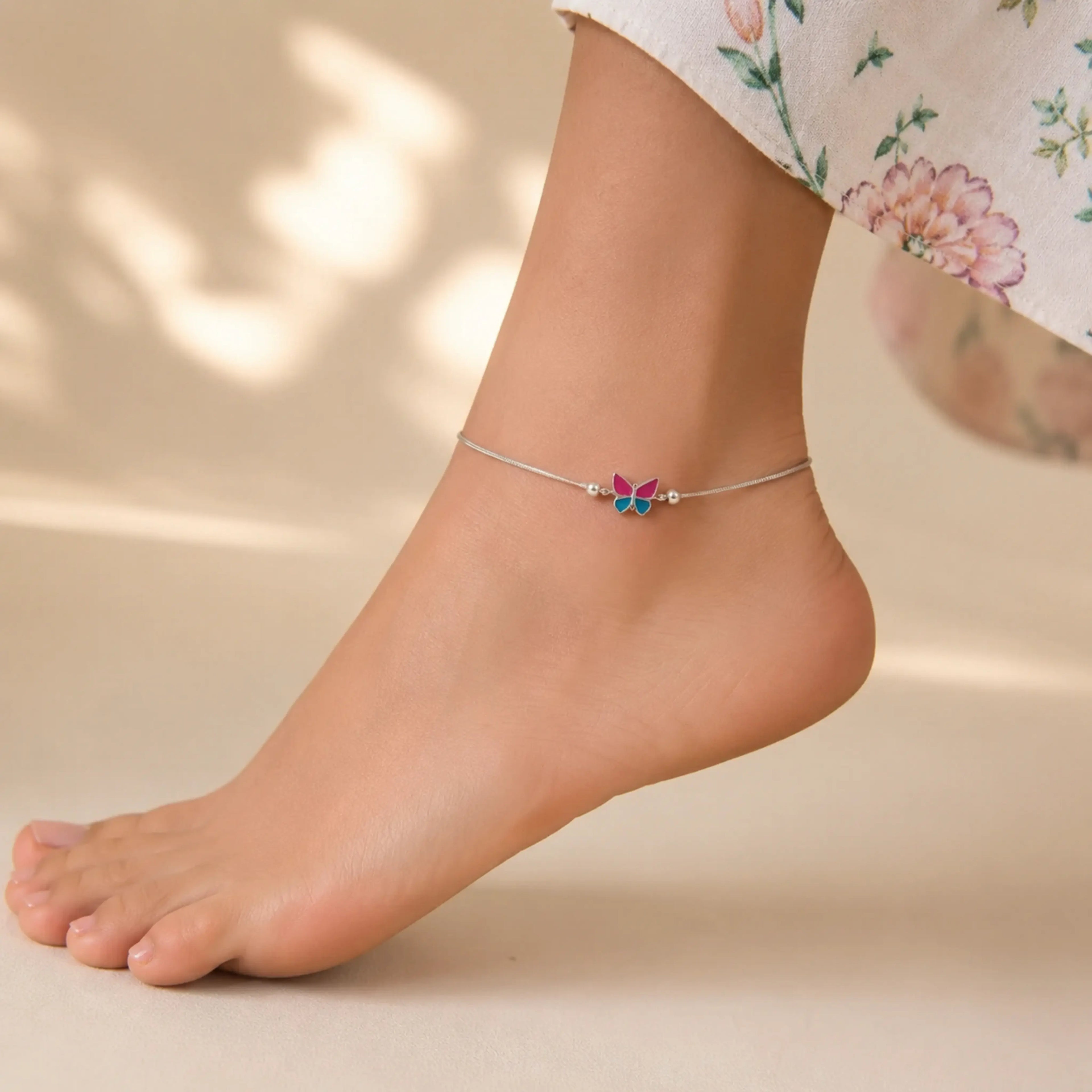 Sterling silver butterfly anklet pair with dual-tone finish featuring fluttering butterfly charms on delicate chain.