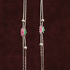 Close up of Twin-Strand Lotus Bloom Anklet Pair on maroon background