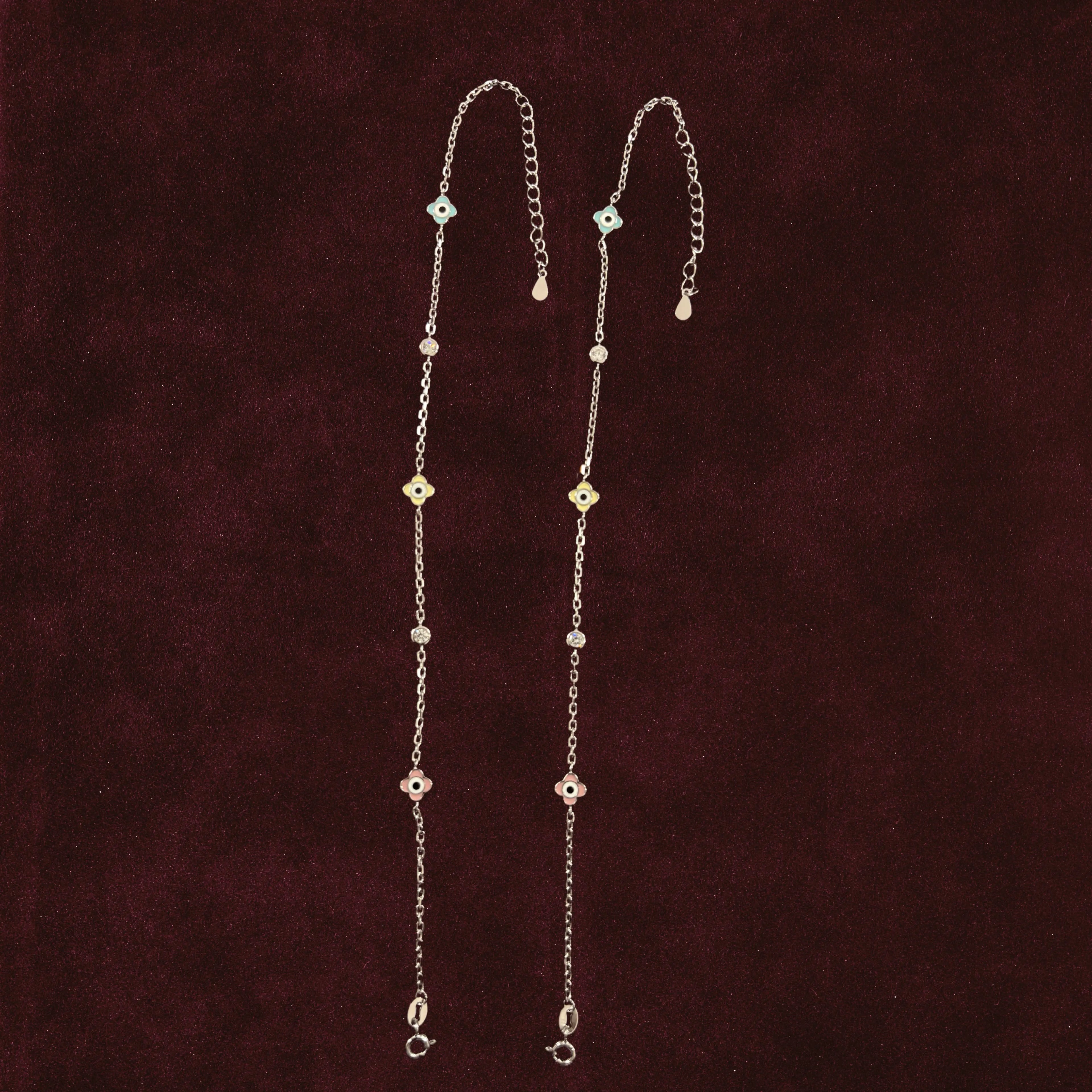 Vigilant Glimmer Multi-Color Charm Anklets Anklet Pair on maroon background