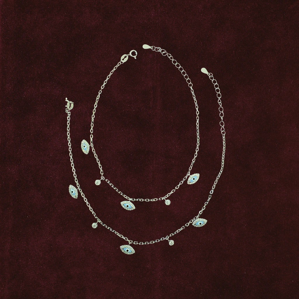 Neelima Glimmer Evil Eye Anklet Pair on maroon background