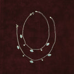 Neelima Glimmer Evil Eye Anklet Pair on maroon background
