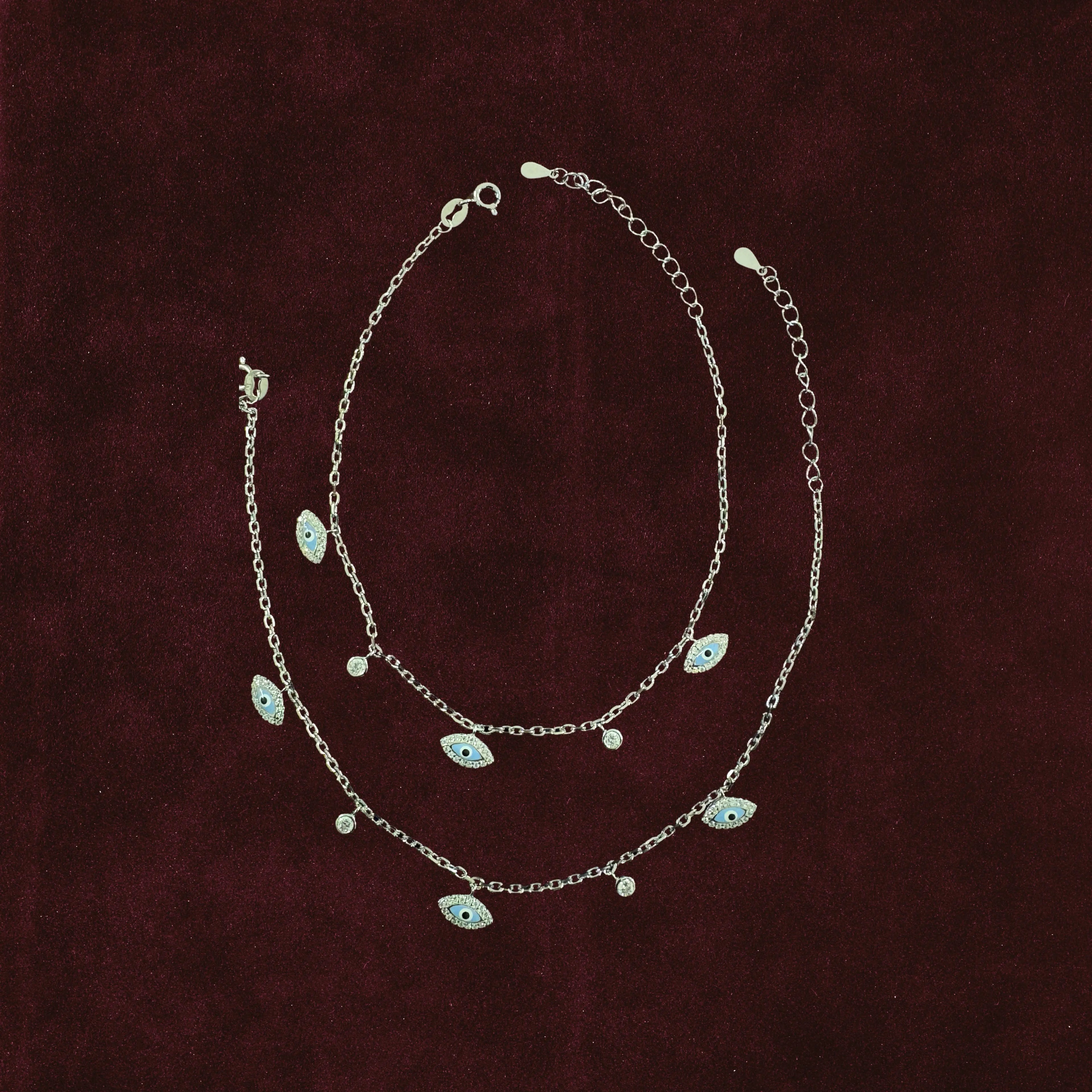 Neelima Glimmer Evil Eye Anklet Pair on maroon background