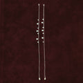 Aura Guard Charm Anklet Pair on maroon background