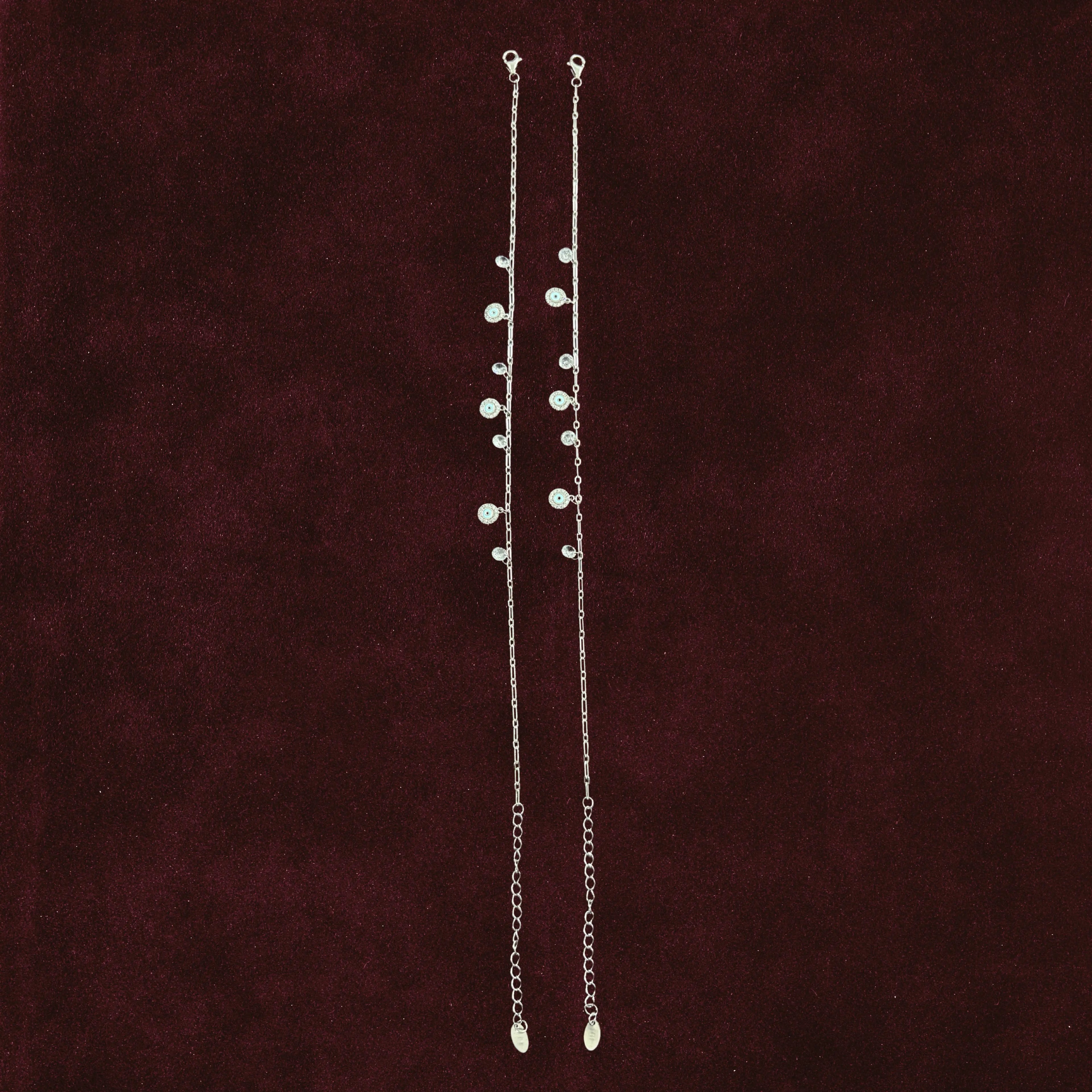 Aura Guard Charm Anklet Pair on maroon background