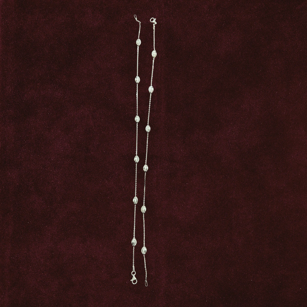 Sculpted Oval Link Anklet Pair on a maroon background