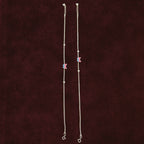 Fluttering Dual-Tone Butterfly Anklet Pair on a maroon background