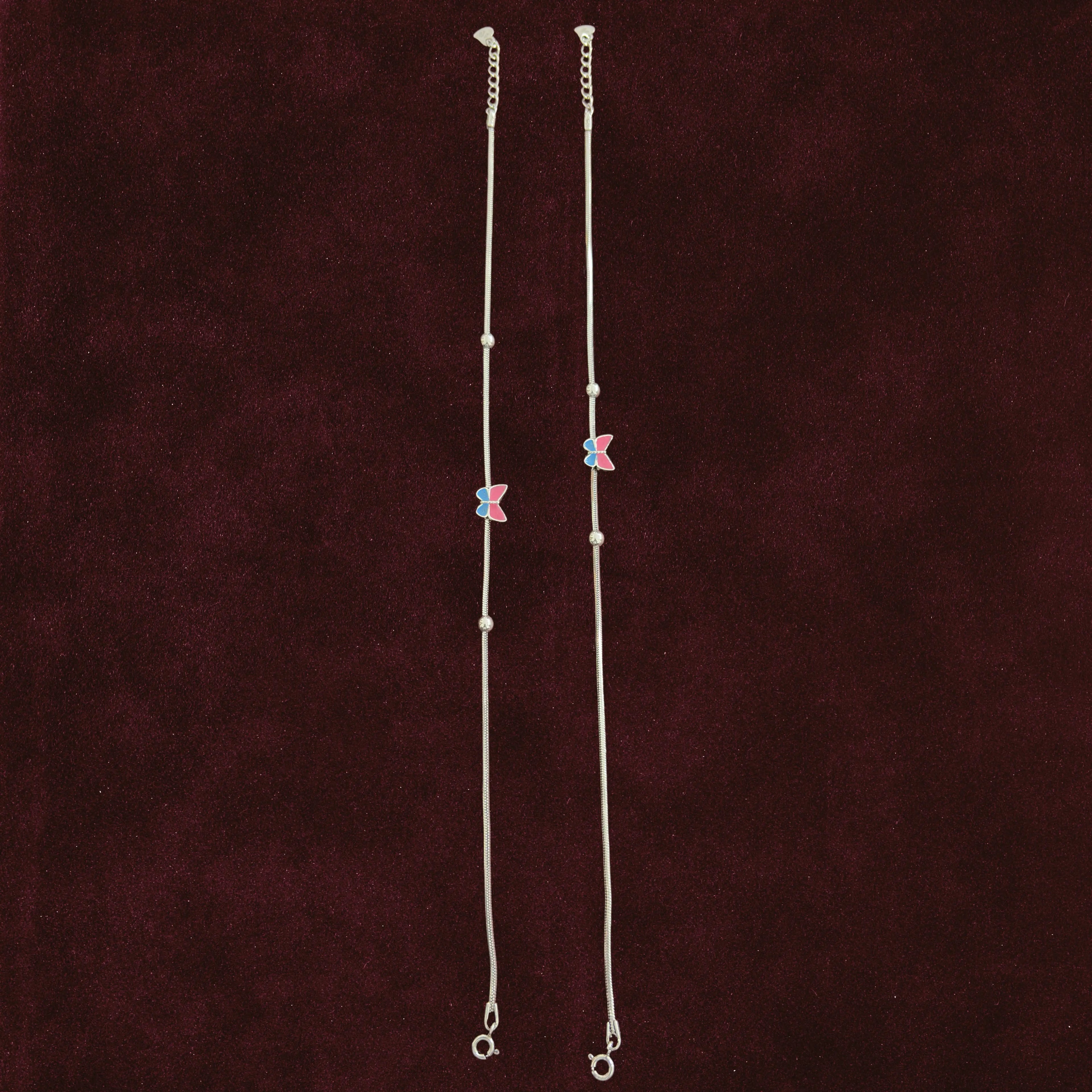Fluttering Dual-Tone Butterfly Anklet Pair on a maroon background