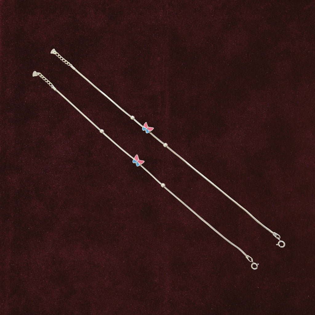 Fluttering Dual-Tone Butterfly Anklet Pair on a maroon background