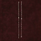 Celestial Orbit Anklet Pair on a maroon background