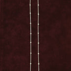 Silver dew drop anklet pair on maroon background