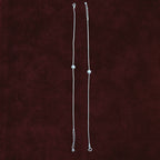 Silver Orb Snake Chain Anklet Pair on maroon background