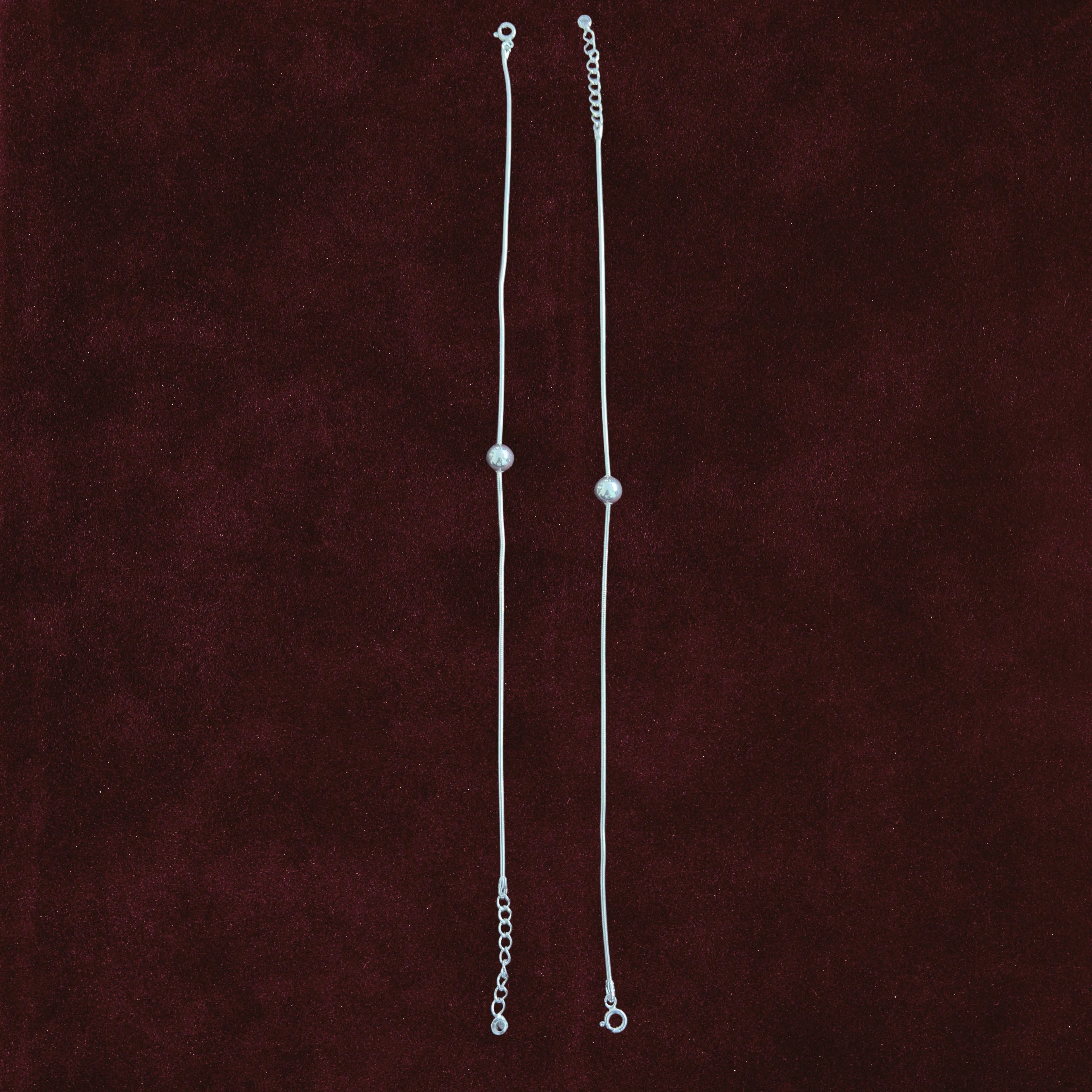 Silver Orb Snake Chain Anklet Pair on maroon background