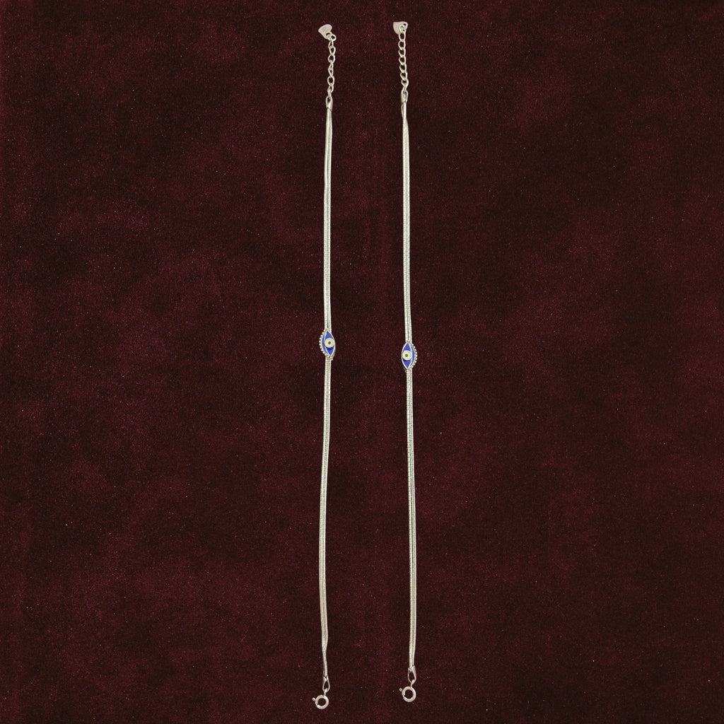 Sapphire Evil Eye Anklet Pair on a maroon background