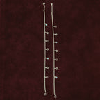 Starlit Charm Anklet Pair on a maroon background