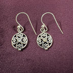 Ornate Filigree Sterling Silver Earrings on maroon background