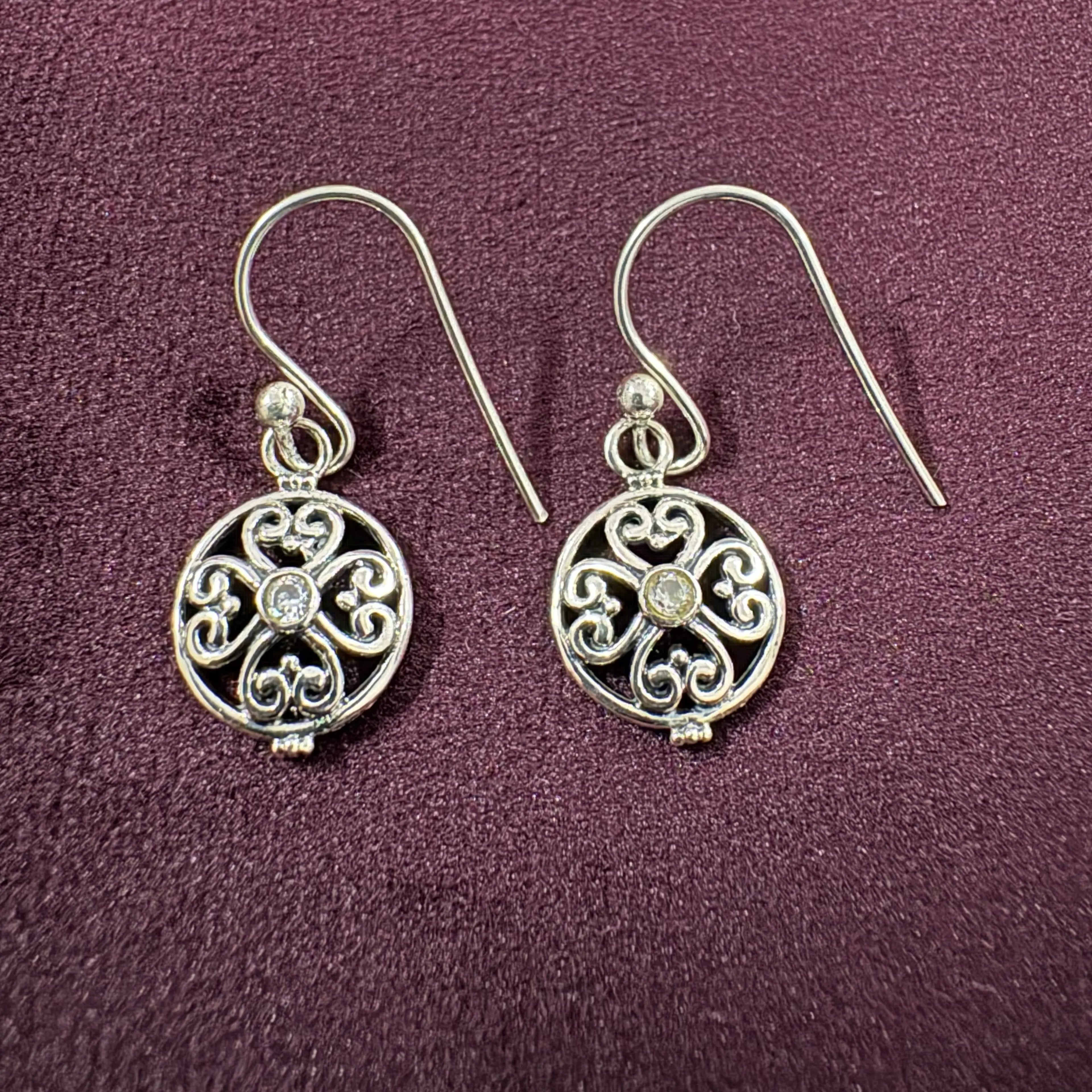 Ornate Filigree Sterling Silver Earrings on maroon background