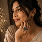 Woman wearing a victoria ring, with a soft focus background