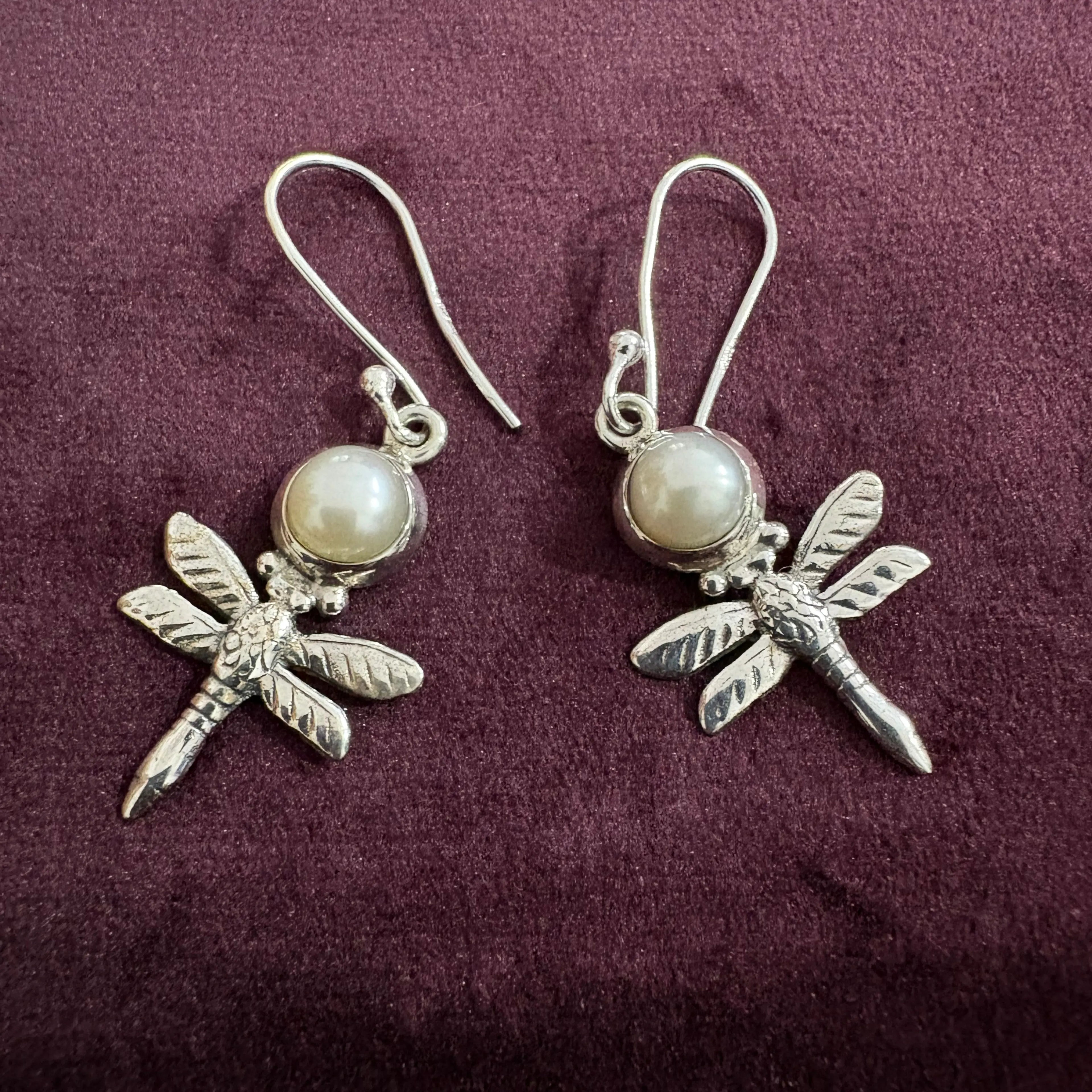 Pearl Dragonfly Sterling Silver Earrings on maroon background