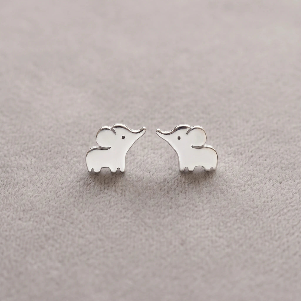 Silver elephant-shaped earrings on a light gray background
