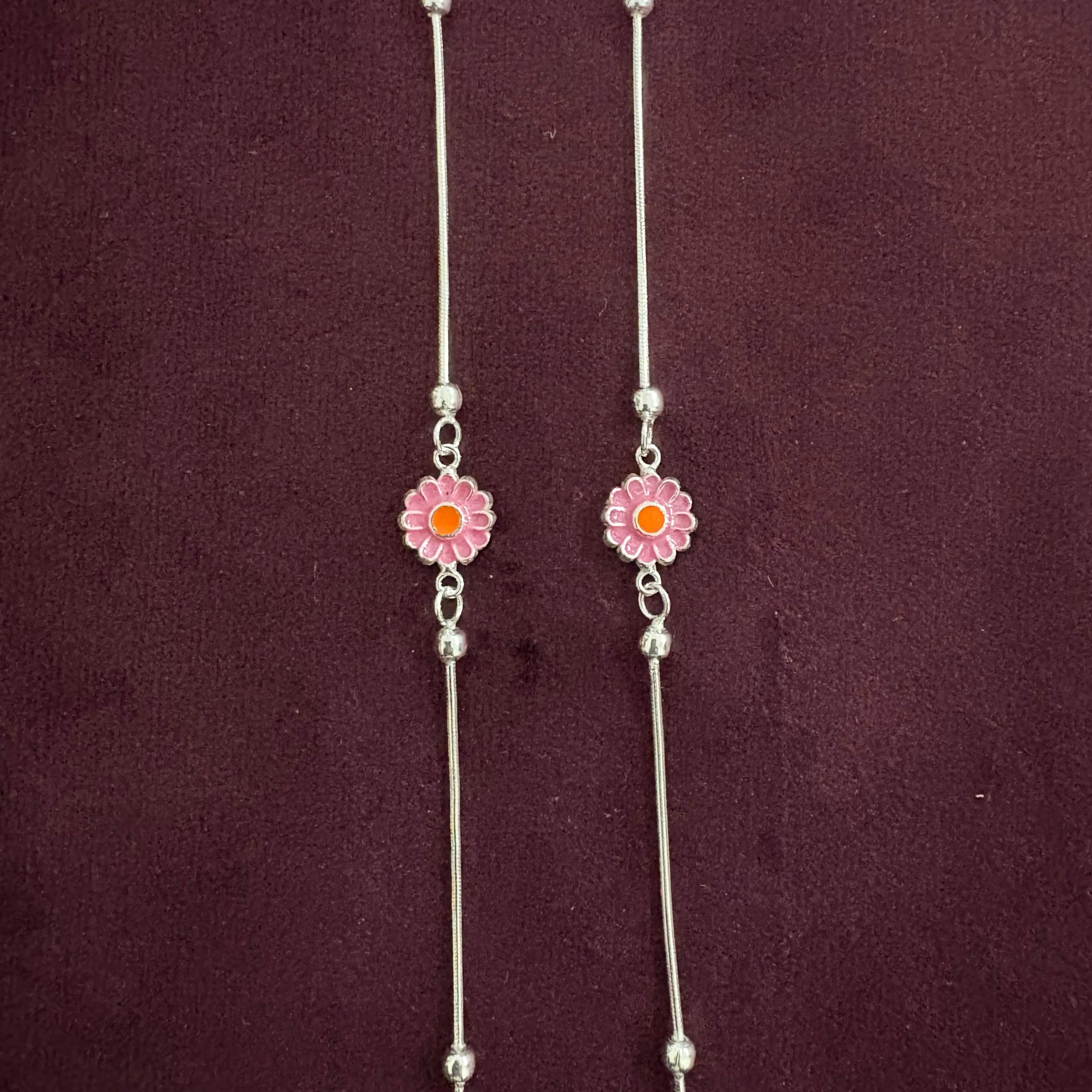 Radiant Daisy Anklet Pair close up on maroon background