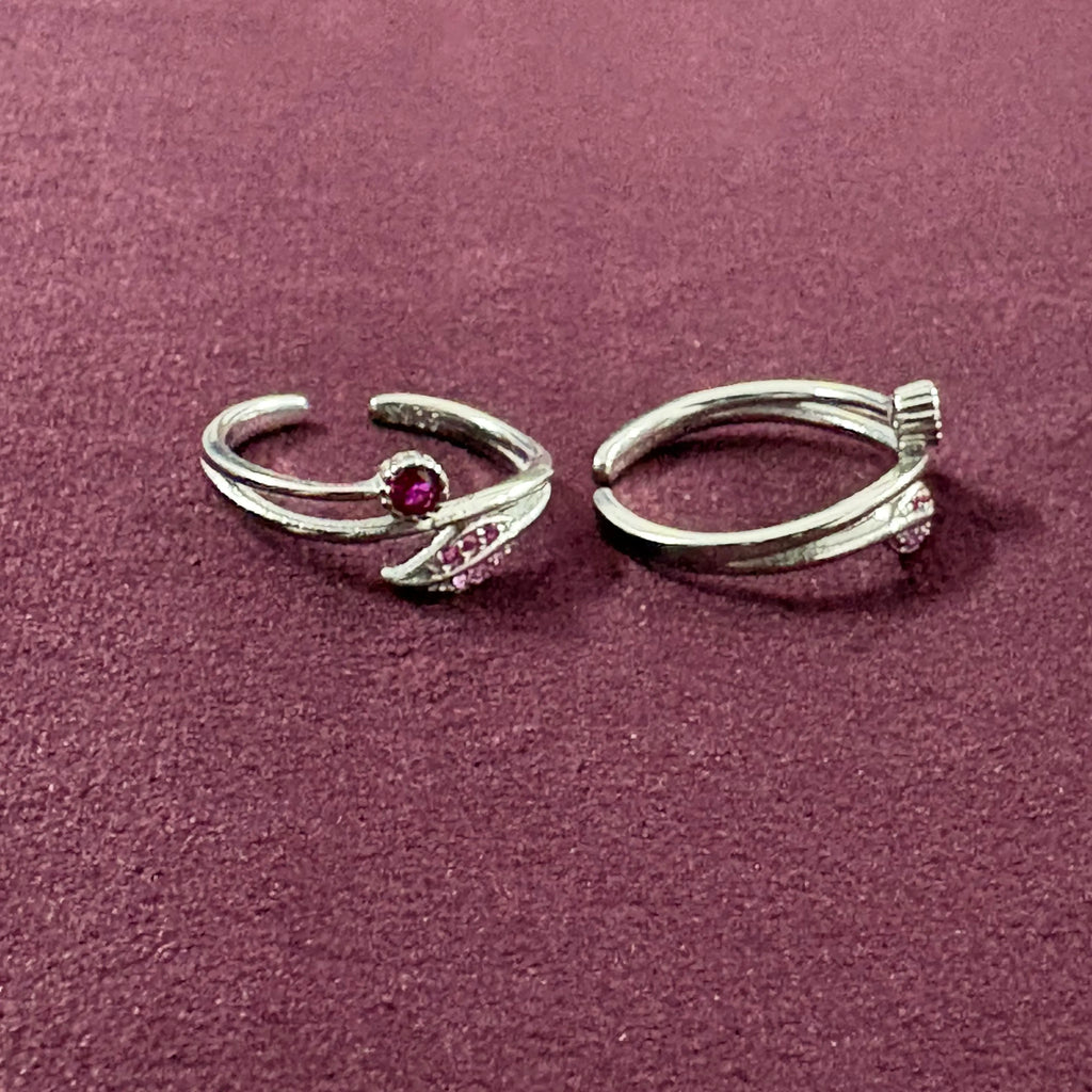 Ruby Rosebud Dual Arch Toe Rings on maroon background