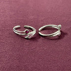 Ruby Rosebud Dual Arch Toe Rings on maroon background
