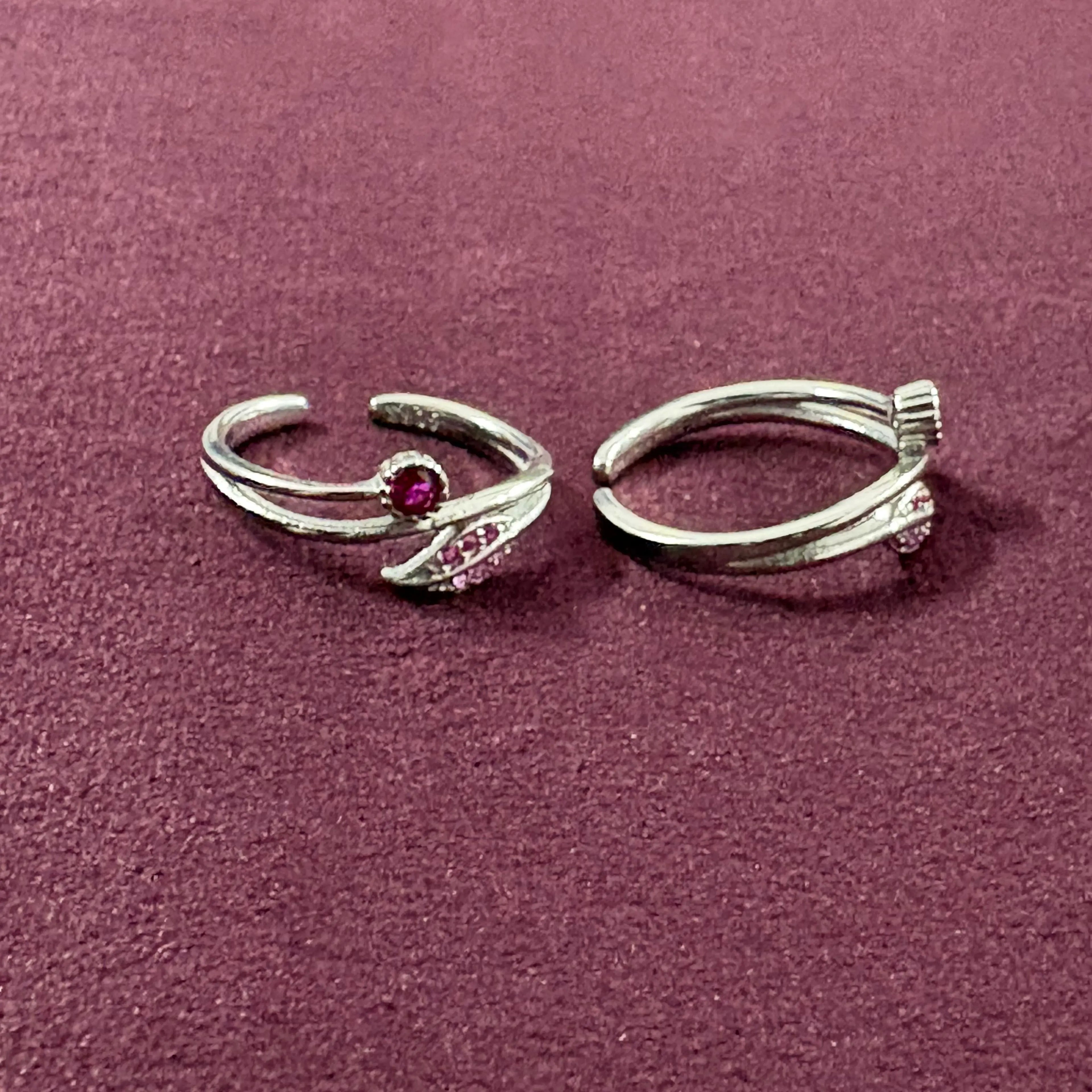 Ruby Rosebud Dual Arch Toe Rings on maroon background