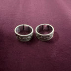 Oxidized Celtic Braid Toe Ring pair on maroon background