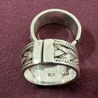 Flat lay image of Oxidized Celtic Braid Toe Ring pair on maroon background