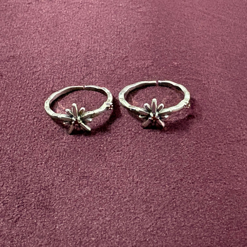 Starry Flora Oxidised Toe Rings on maroon background