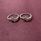 Starry Flora Oxidised Toe Rings on maroon background