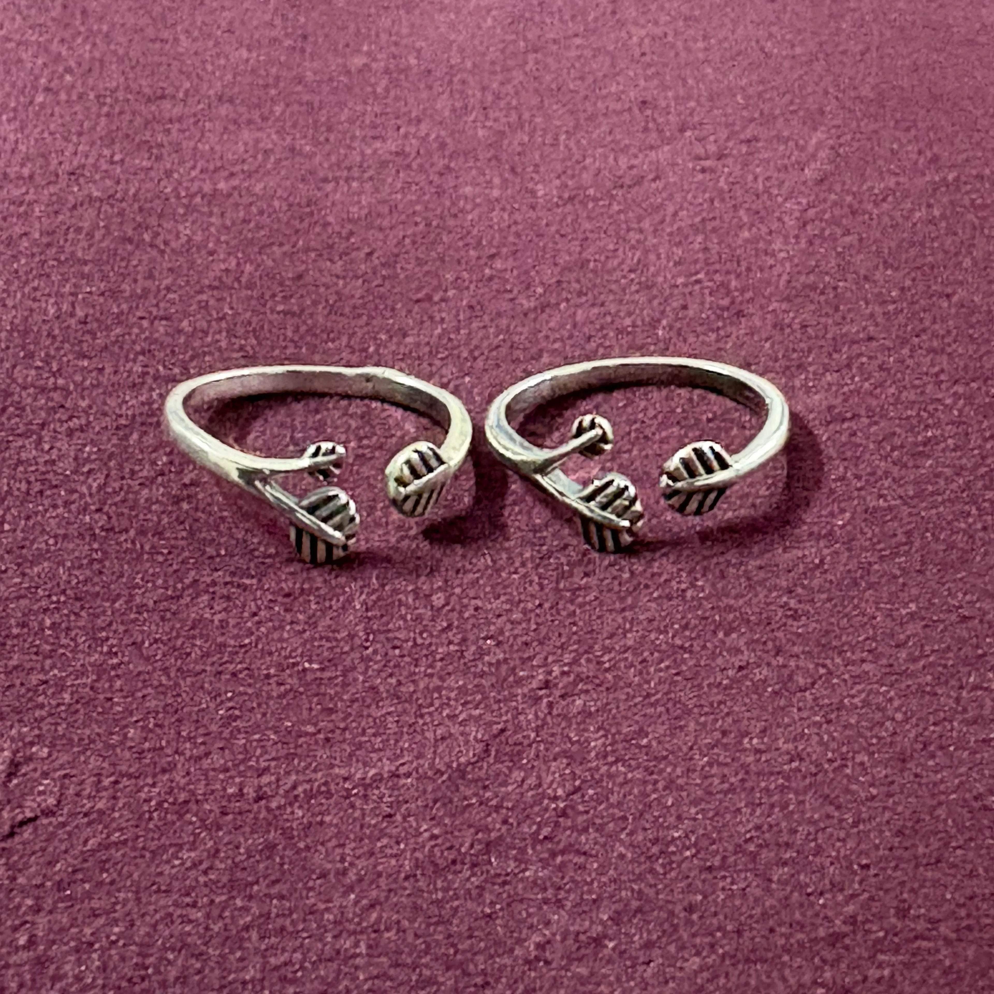 Triple Leaf Open-Front Toe Rings on maroon background