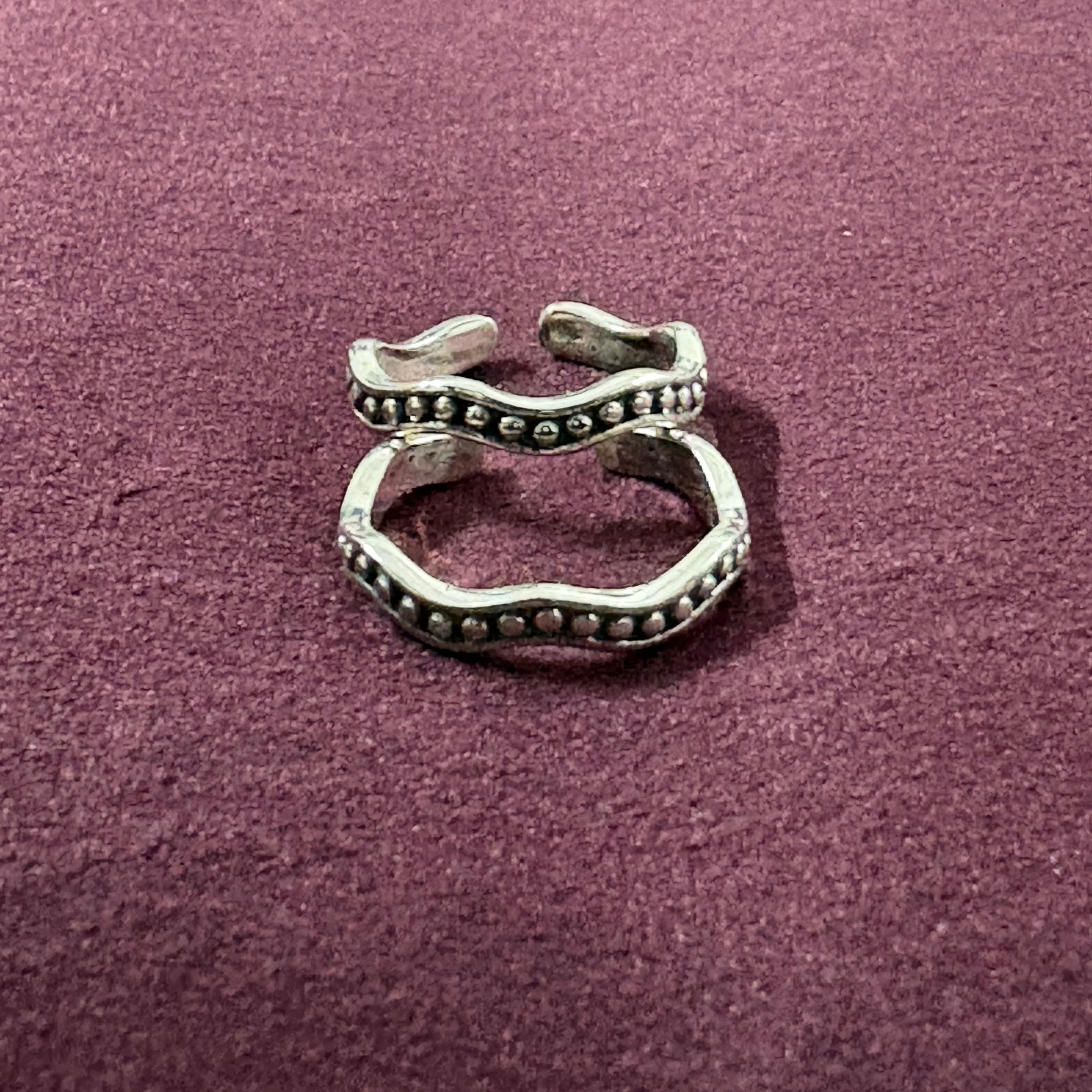 Wavy Beaded Oxidized Band Toe Rings on maroon background