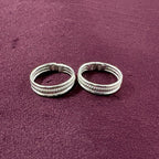Triple-Tier Rope Textured Band Toe Rings on maroon background