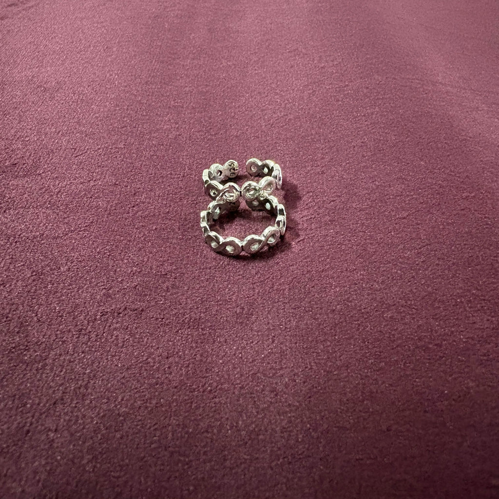 Infinity Link Oxidized Toe Rings on maroon background