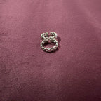 Infinity Link Oxidized Toe Rings on maroon background