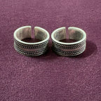 Braided Oxidized Band Toe Rings on maroon background