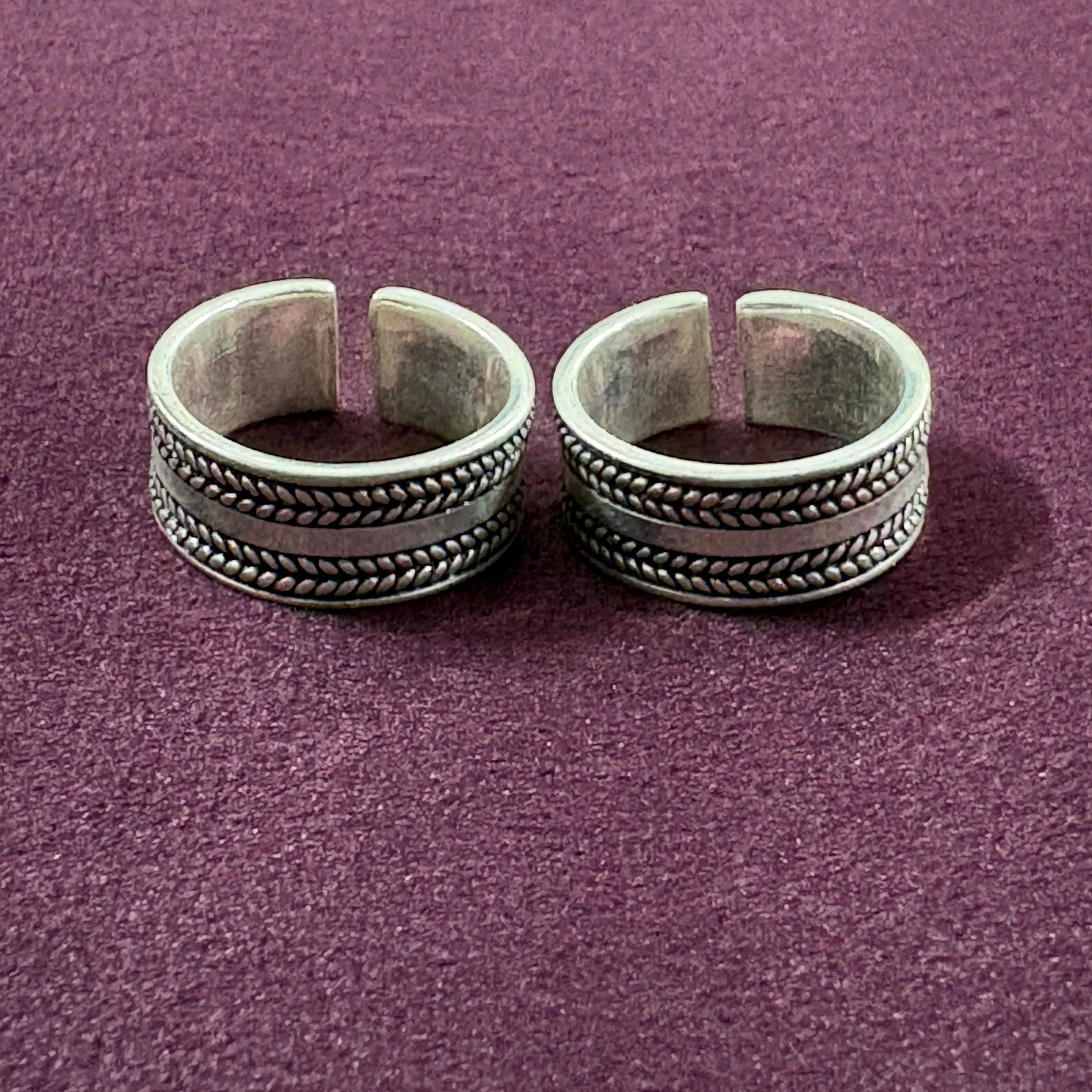 Braided Oxidized Band Toe Rings on maroon background