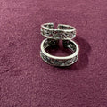 Intricate Filigree Oxidized Toe Rings on maroon background