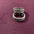 Intricate Filigree Oxidized Toe Rings on maroon background