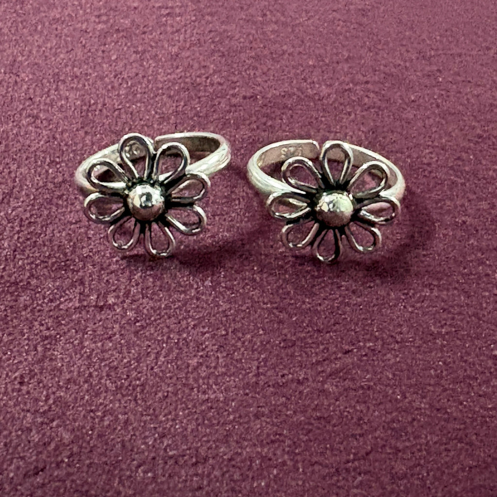 Wire Flower petal toe ring on maroon background