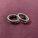 Ivy Leaf toe rings on maroon background