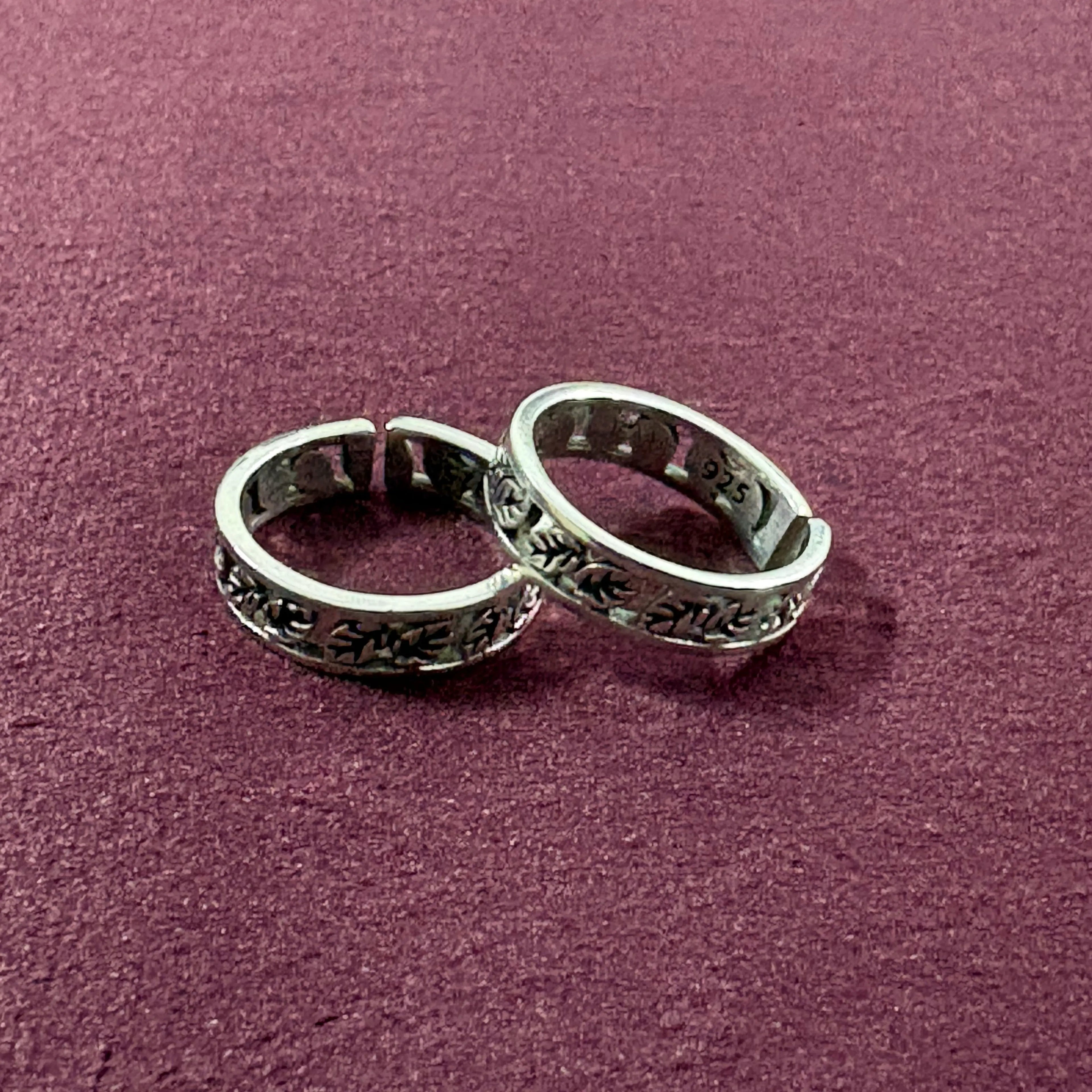 Ivy Leaf toe rings on maroon background
